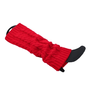 Close-up of red cable-knit leg warmer texture with classic braided pattern