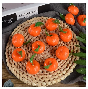 Realistic PVC mini orange models with textured peel and green leaves on a rustic woven mat