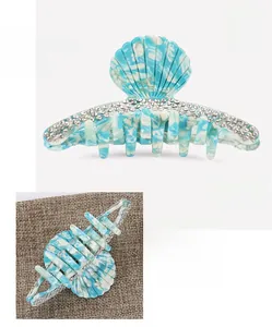 Detail of blue marble acetate hair claw with rhinestones measuring 9.2 by 4.2 cm