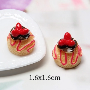 Macro detail of 1.6x1.6cm miniature resin cake model with cream and chocolate coating