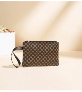 Dettaglio della pochette marrone caffè con motivo a trama, cinturino nero e trama in pelle