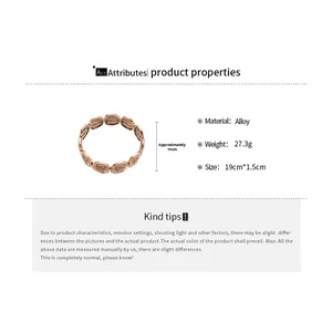 Detail of round bronze metal plates on elastic bracelet showing engraved religious text