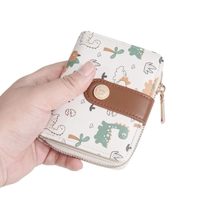 Detailed view of women short wallet featuring cute dinosaur print and metal snap closure