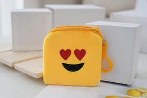 Detail of yellow plush coin purse with red heart eye embroidery and plastic hook
