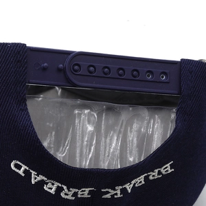 Rear view of navy blue cotton snapback cap showing plastic strap and white embroidery