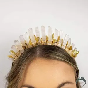 Detail of golden leaf crown featuring natural crystals on a model with a white background