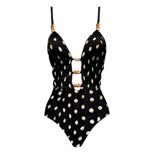 Detailed view of the deep V-neckline with gold ring buckles and white polka dots on the swimwear