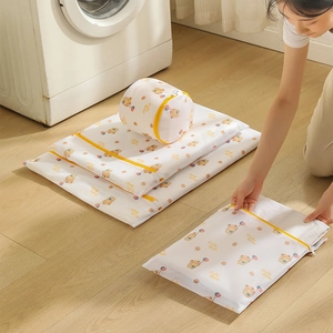 Cute bear print laundry mesh bag set with yellow zipper in a cozy laundry room scene