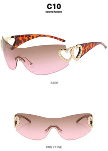 Detail of Y2K gradient oversized sunglasses showing side and front view with heart accents