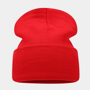 Close-up of vibrant red rib-knit winter beanie with a classic folded cuff detail
