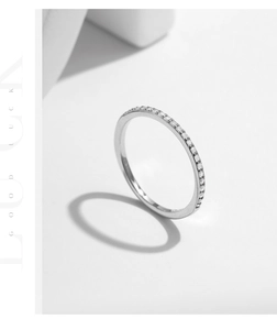 Macro side view of half-eternity S925 silver ring featuring micro-pave moissanite stones