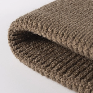 Deep brown ribbed knit beanie hat showing thick warm winter fabric texture and detail