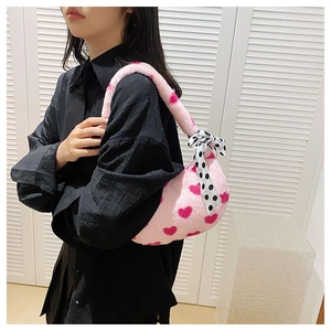 Detail of pink plush tote bag with red hearts and black white polka dot silk scarf