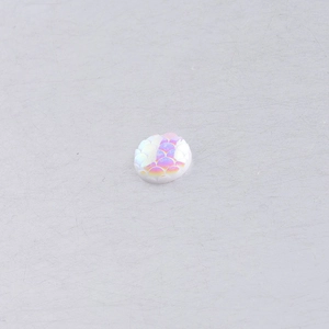 Macro shot of 10mm round resin fish scale cabochon with iridescent AB finish