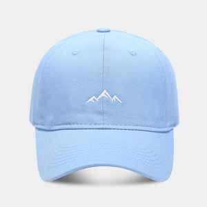Close-up of a light blue cotton baseball cap featuring detailed white mountain embroidery