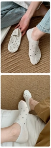Close-up of beige and white polka dot no-show socks with low-cut knit cotton design