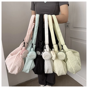 Detailed view of puff quilted crossbody bags in multiple colors with matching coin purses