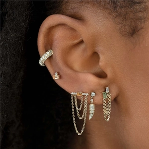 Close-up of S925 silver fringe chain earrings with green and orange gemstones on model