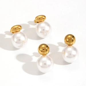 Elegant gold metal ball and large white pearl stud earrings on a clean white background