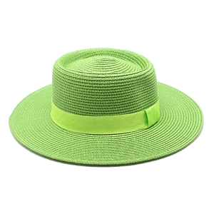 Detail of bright green woven boater hat with matching satin ribbon for sun protection