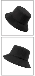 Detailed views of a black sun protection bucket hat with a wide brim and minimalist design