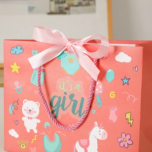 Pink 'It's a Girl' gift bag with silk ribbon for baby showers and newborn celebrations