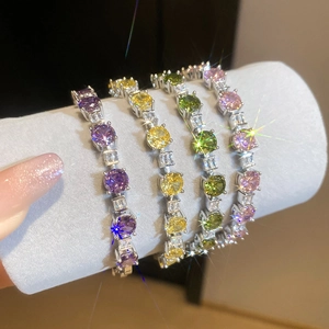 Close-up of four colorful tennis bracelets with sparkling zircons on a jewelry display