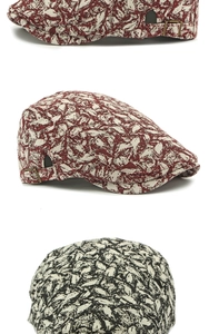 Detail view of ethnic jacquard beret showing adjustable metal buckle and leaf pattern