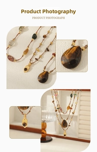 Macro detail of Tiger Eye teardrop pendant and handmade gemstone beaded necklace