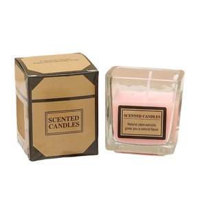 Pink scented candle in square glass jar with brown kraft paper box on white background