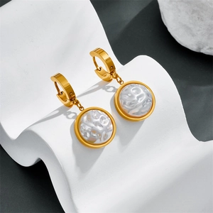 Vintage style gold round earrings featuring baroque irregular pearls on a white wave stand