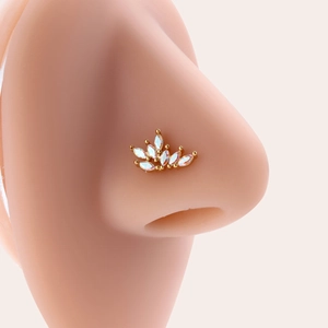 Golden titanium steel L-shaped nose stud with iridescent flower gem on a model