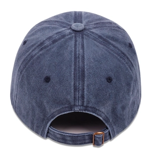 Detail of vintage washed blue baseball cap showing cotton twill fabric and bronze metal buckle