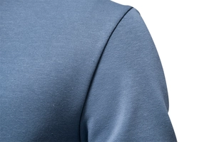 Detailed macro view of gray-blue cotton sweatshirt shoulder stitching and knit texture