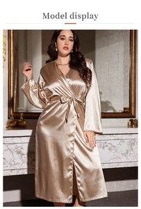 Detailed macro view of champagne gold satin robe fabric with silky smooth texture