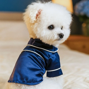 Close-up of a dark blue satin pet pajama with elegant white piping on a dog model