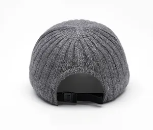 Detail view of the gray knitted baseball cap back showing adjustable buckle and ribbed texture