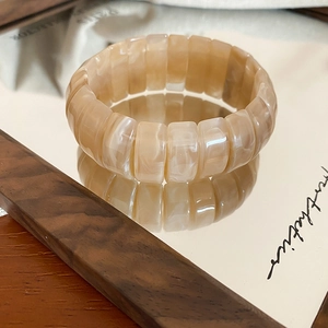Macro detail of elastic resin bracelet with marble texture and polished block design