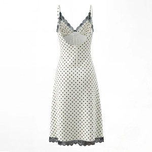 Detail of polka dot dress with delicate black lace trim and sexy open back tie design