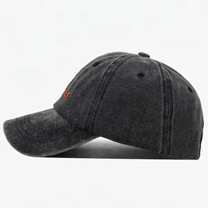 Retro washed dark grey baseball cap with orange embroidery shown in a side view