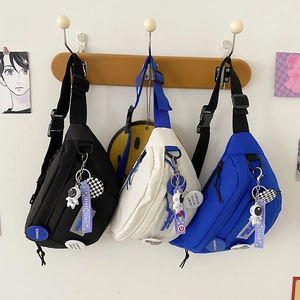 Nylon sling bags in black, beige, and blue with cute astronaut astronaut pendants