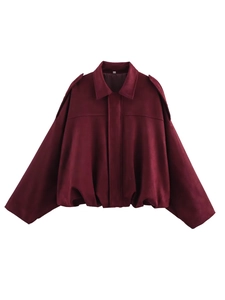 Detailed view of the burgundy suede texture and elastic hem on this short jacket for women