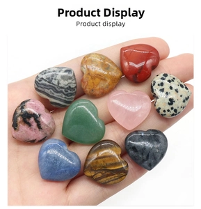 Close-up of polished heart-shaped natural crystal stones in various colors and textures