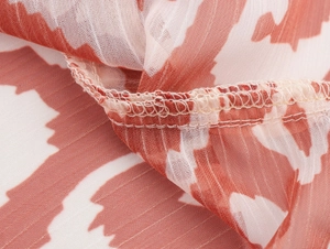 Détail macro du tissu mousseline respirant avec rayures rouges et couture d'ourlet