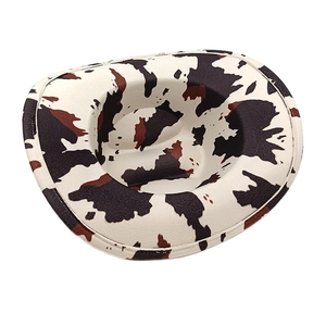 Detailed close-up of cow print cowboy hat showing texture and wide bound edge brim