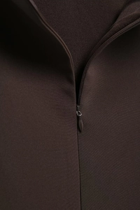 Close-up of invisible back zipper on coffee brown layered mesh dress with fabric texture