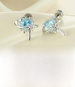 Detail view of heart-shaped zircon earrings with star trail design and surgical steel post