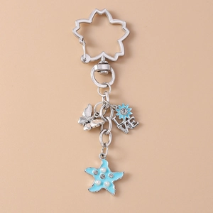 Detailed close-up of cherry blossom keychain with butterfly and blue starfish charms