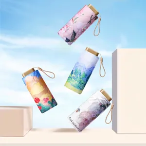 Mini capsule umbrellas with oil painting art prints and champagne gold handles