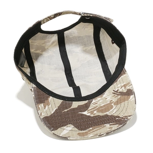 Internal view of five-panel desert camo cap showing sweatband and reinforced stitching